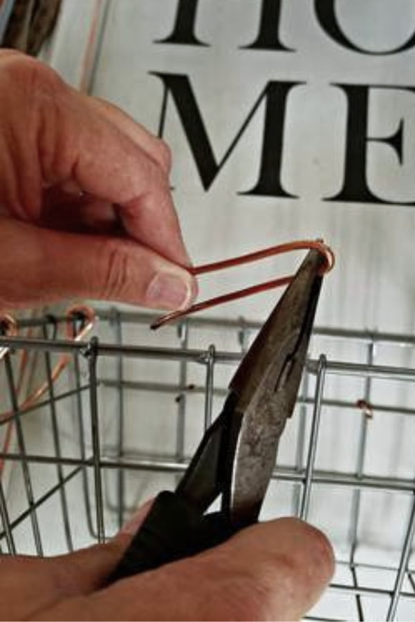 I secured the baskets to the cabinet door with copper wire that matched the basket.