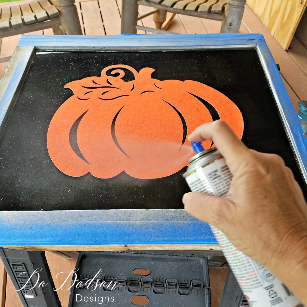 I sprayed over the dollar store felt pumpkin to create a masking effect.
