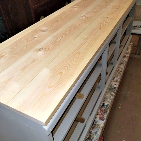 This wood dresser/bench project is getting a brand new look with a beautiful stained top.