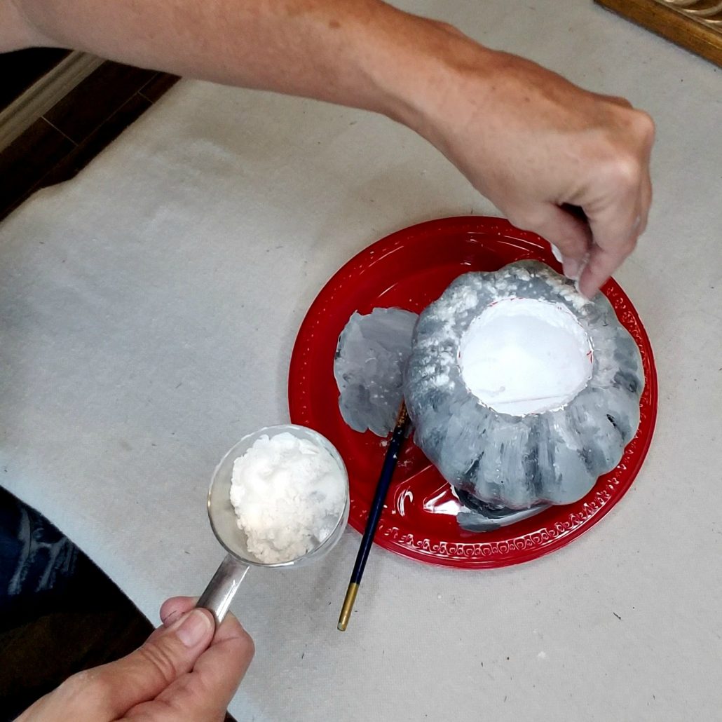 Flour? It's the secret sauce to creating a faux concrete finish on a dollar tree pumpkin.