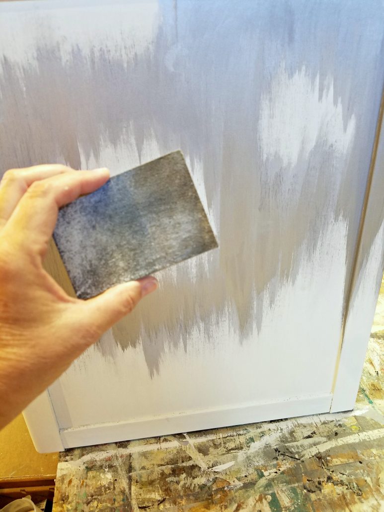 I lightly sanded and distressed the surface of the cabinet before adding the gold leaf. #dododsondesigns #goldleaf #metallic #silver
