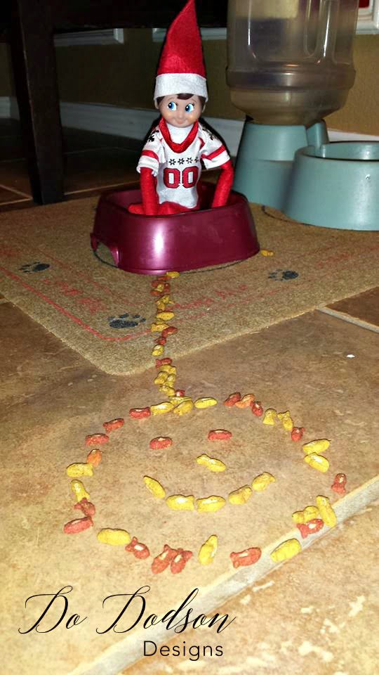 Elf on the shelf mischievious ideas taunting the cats. 