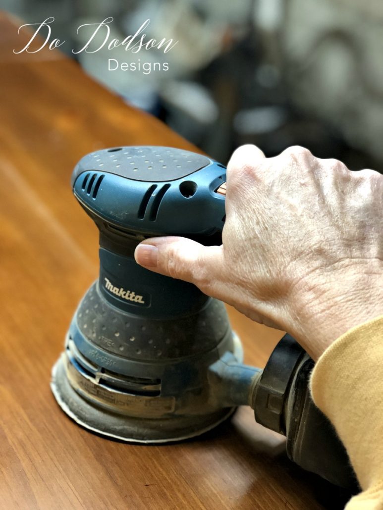 I use an orbital sander to gently scuff the wood before painting it.