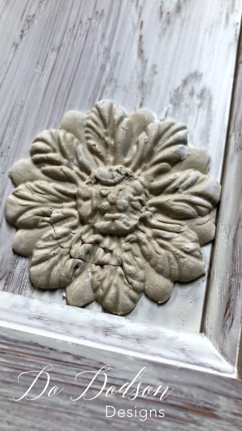 I added these beautiful decor moulds to a cabinet door to create unique wall art.