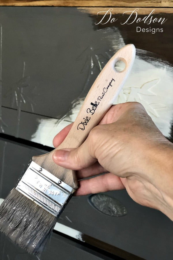 After applying the slick stick to the mother of pearl furniture inlay, I painted over the whole piece with Dixie Belle's chalk mineral paint. I love this color and it will look lovely with the raw wood top. #furnitureartist #dododsondesigns #paintedfurniture #furnituremakeover #diyproject #diyhomedecor #motherofpearl