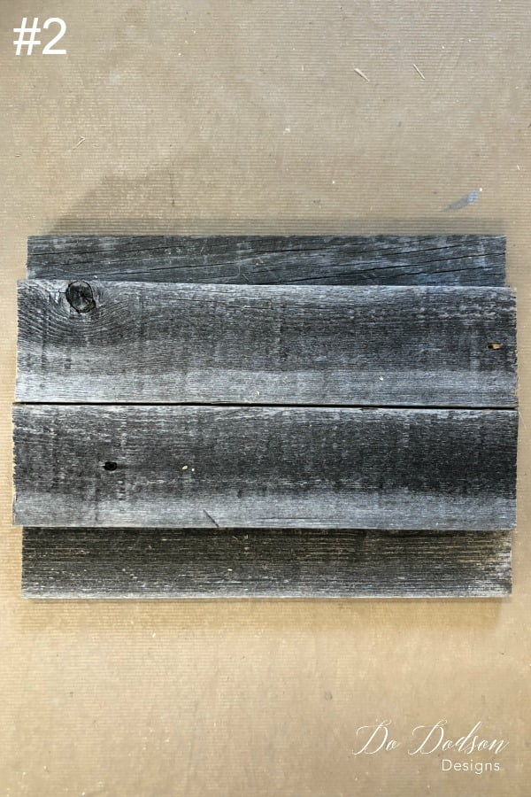 The #2 step in making DIY wood pumpkins is to stack 2 boards on top of the 3 bottom ones.
