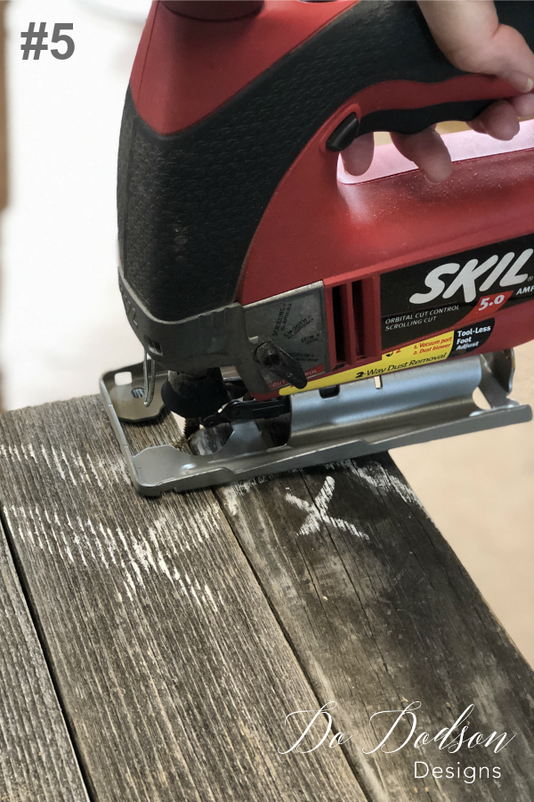 The 5th step in making DIY wood pumpkins it to carefully cut your design with a jigsaw.