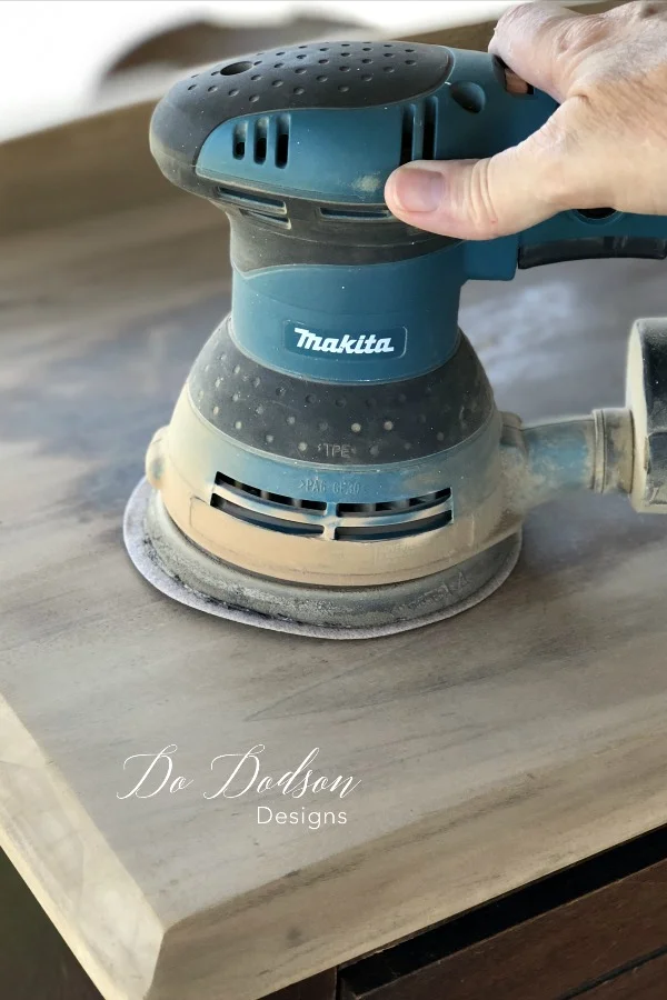 I used a rotary sander to remove the old varnish on my thrift furniture find before I painted it.