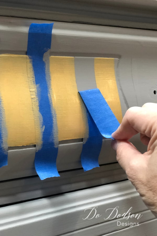 I used Dixie Belle's Metallic Gold based coat for the stripes. The paint was transparent so it took applying three coats to get the coverage the way I wanted. I removed the tape before the last coat was dried.