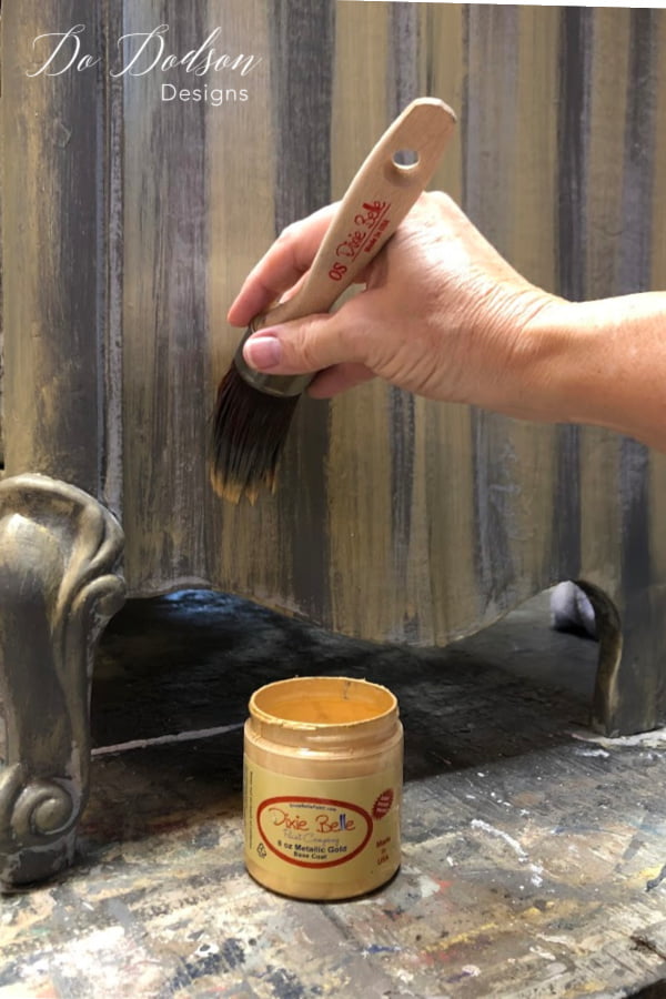 The best chalk paint. With my oval short paint brush I began painting/dry brushing stripes in alternating colors of the Metallic Gold and Hurricane Gray over the Drift Wood base coat. I really liked the look of the stripes that weren't so perfect. After the paint had dried, I sanded over the whole dresser with a 220 grit sandpaper to give it a distressed age look.