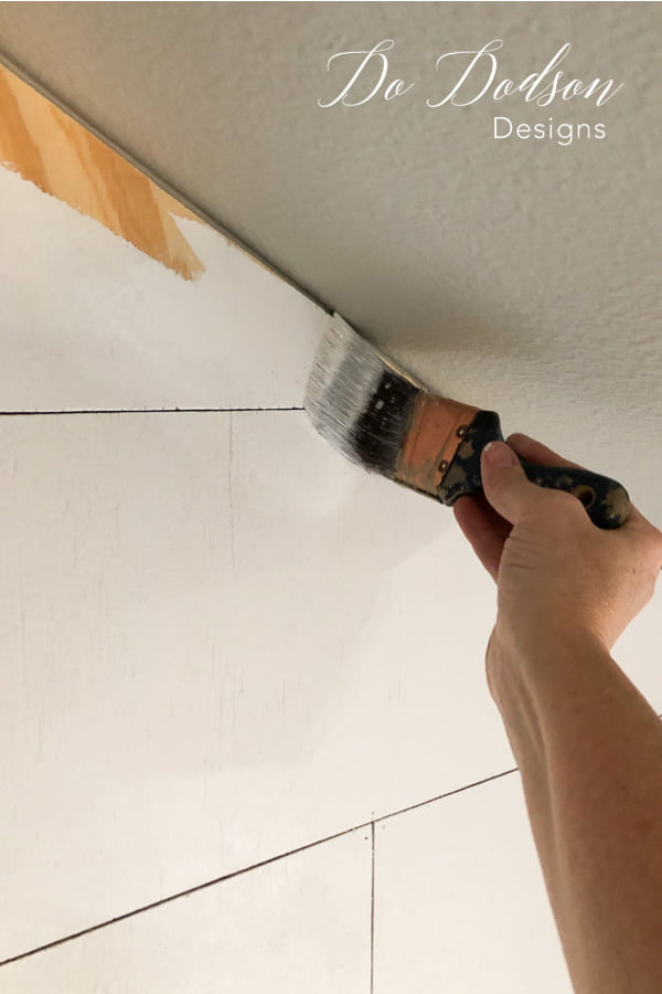 Painting with a real great primer is key when painting over plywood used to create a faux shiplap wall.