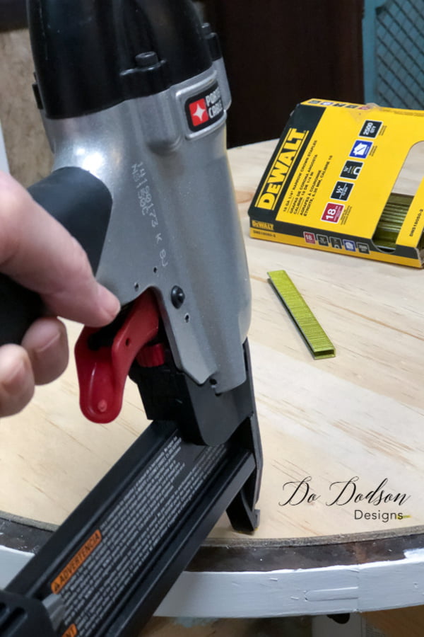 Stapling the wood backing to the frame made with reclaimed wood.