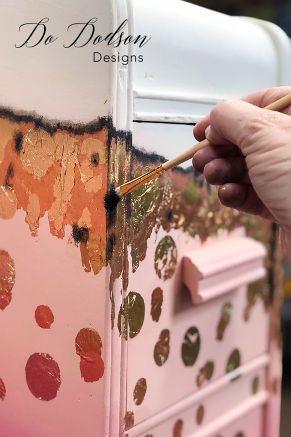 Black gilding wax added to copper and gold leaf.