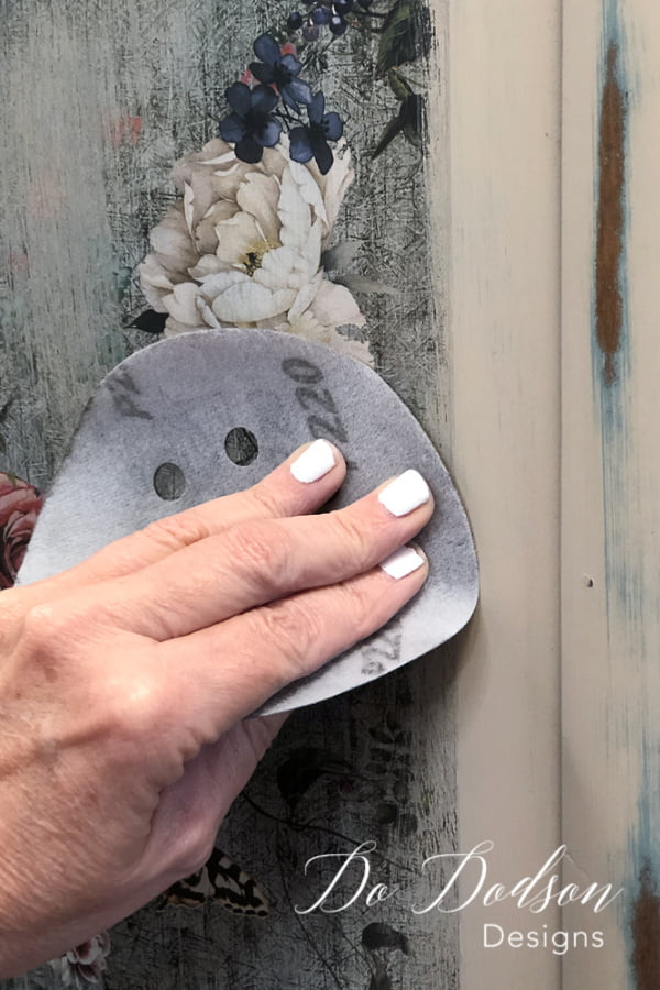 I used a 220 grit sandpaper to distress the floral transfers for furniture to create an aged look.