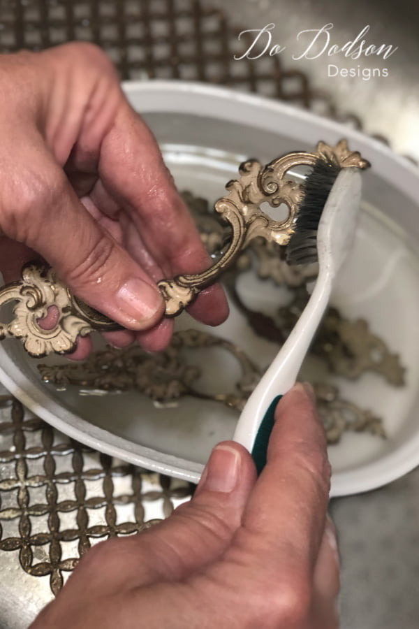 Lightly scrub away old paint and years of grime before spray painting hardware. A toothbrush works well.