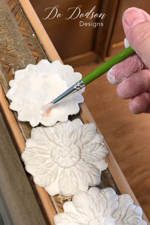 I created decor moulds to add detail to a plain Jane piece before painting with metallic paint.