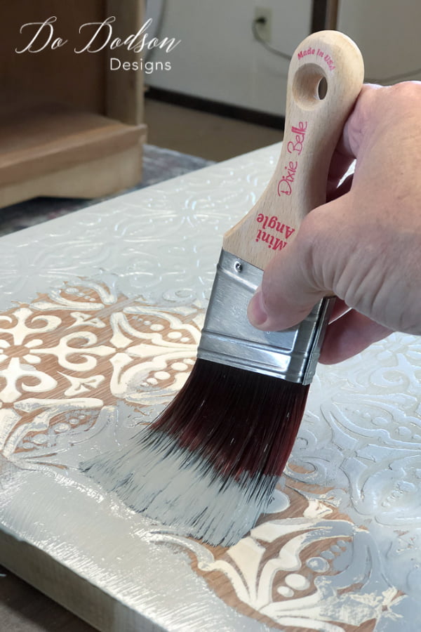 You can paint right over the raised stencil once it's dry.