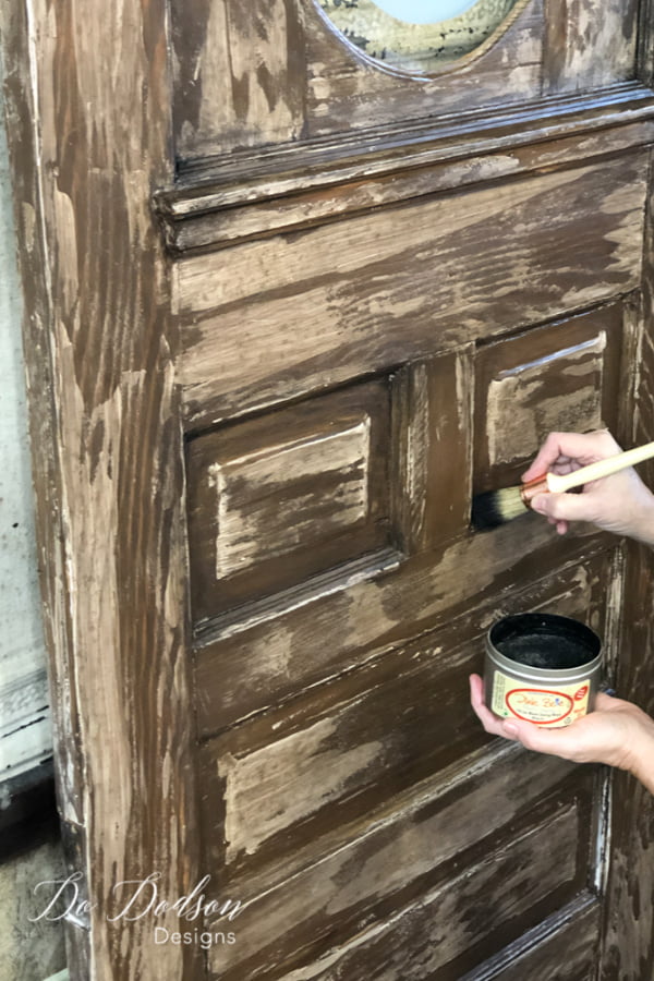 I used Black wax and applied it with a french tip brush to get into the corners and blended it well over the chippy paint technique.