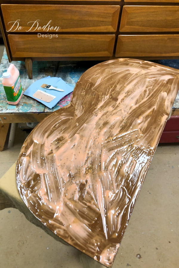 Apply the Citri-Stripe orange gel liberally to the backside of the antique mirror with a chip brush or an old brush you don't mind throwing away. It's a pretty messy process antiquing a mirror. Then you wait!