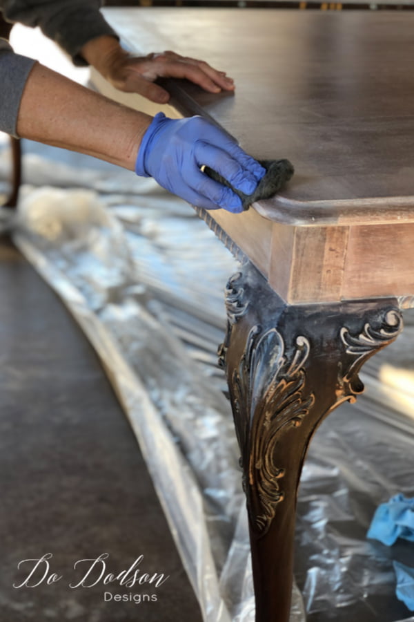 After applying the whitewash wood stain to the table, I used a ball of super-fine steel wool to buff the whitewashed wood. I use it like super-fine sandpaper and it gives it one last buffing before the protective topcoat. The look is stunning in my farmhouse dining room.