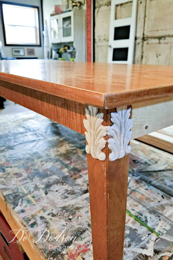 The application of the decorative mouldings was easy. I added little wood glue on the back of the moldings and applied it directly to wood legs while it was still wet. This allowed me to form the mold to the legs so they would lay flat as they dried. If the had been rounded on this table, it would have been easy to curve them in the direction of the wood. So fun!