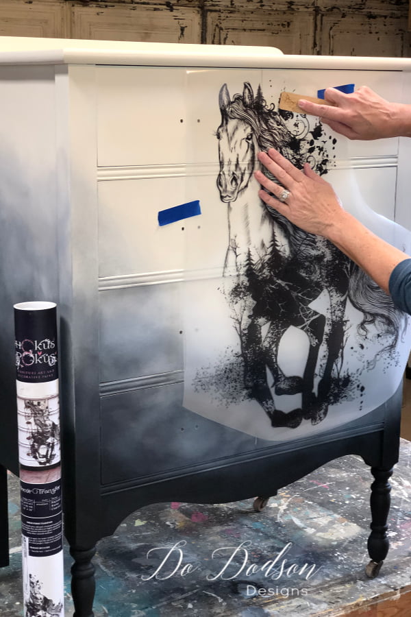 Determine the location on your painted furniture that you want the transfer to live. I also found that trimming the excess plastic sheet around the transfer was beneficial.
