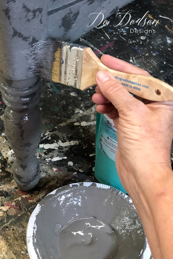 Using a disposable chip brush I dabbed the texture paint all over this end table. The results are going to be amazing!