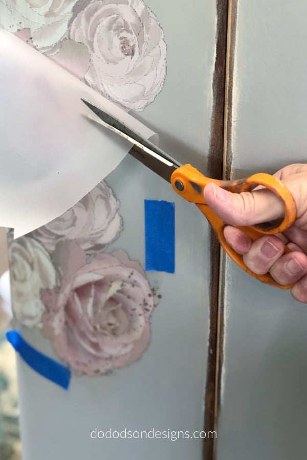As I rubbed the furniture transfer in place, I used a pair of scissors to remove the plastic backing as I moved down the transfer and around the corners. This makes to process so much easier.