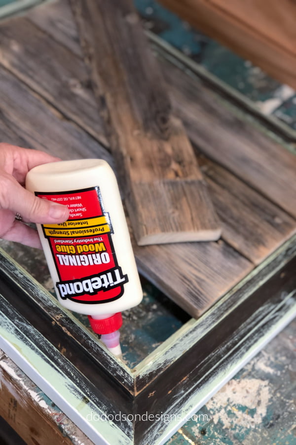 Using wood glue, I added a bead around the picture frame before adding the boards.