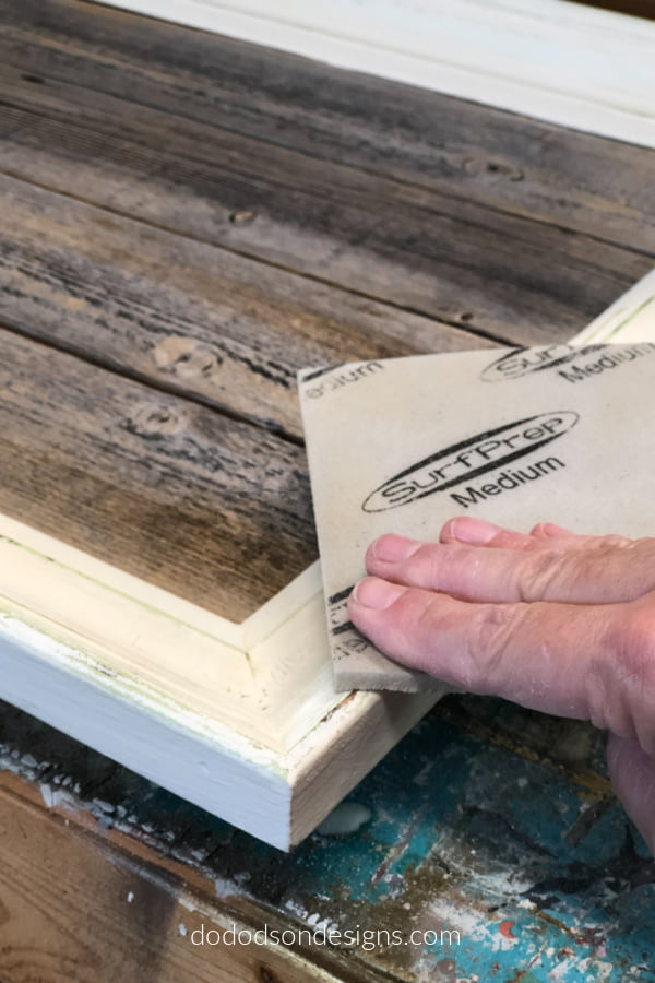 I adding some distressing to the paint on my DIY picture frame tray to add a bit of a rustic farmhouse feel.