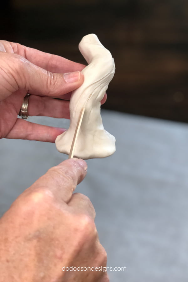To create a natural looking DIY pumpkin stem I used a craft stick cut grooves in the clay before baking.