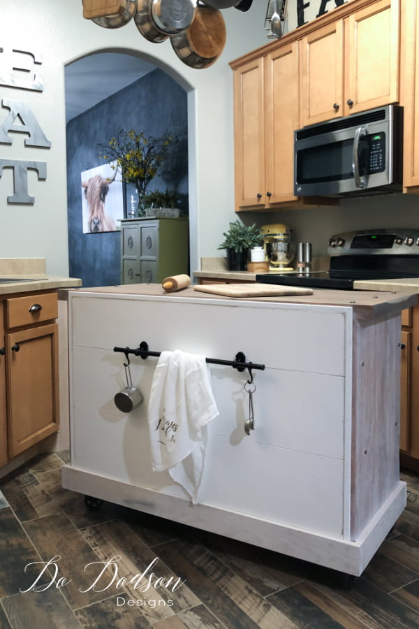 I also used the back of the DIY rolling kitchen island for storage by installing an Ikea steel kitchen organizer. Love those hooks!!!