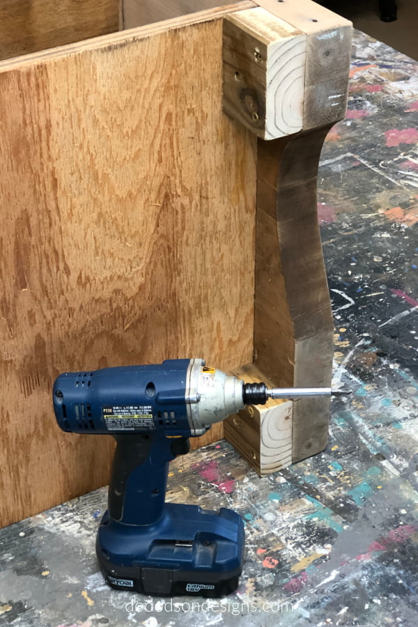 Before attaching the wheels to my DIY rolling kitchen island I modified the legs by adding a piece of 2 X 4 lumber to bulk it up.