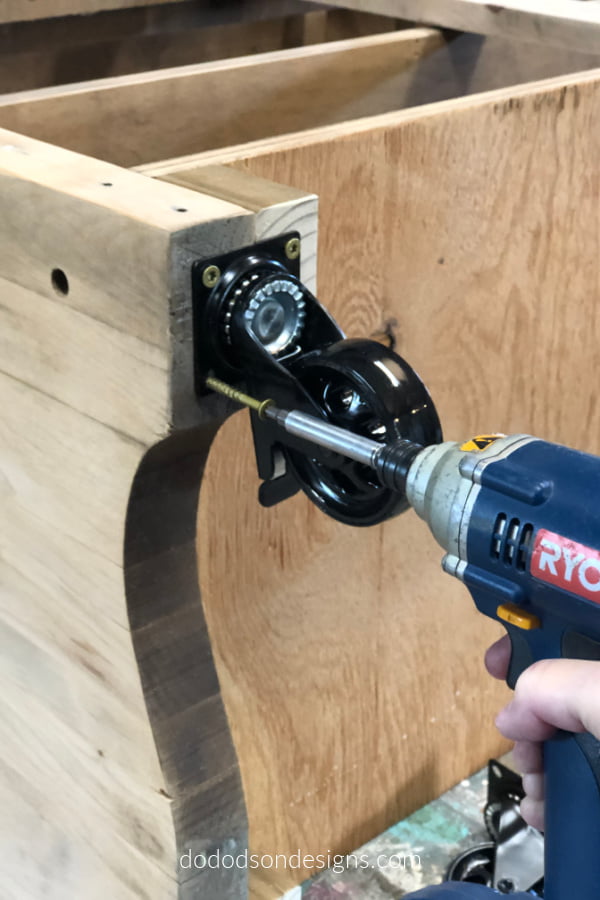 Using a drill and long screws I attached the industrial farmhouse wheels to my DIY rolling kitchen island.