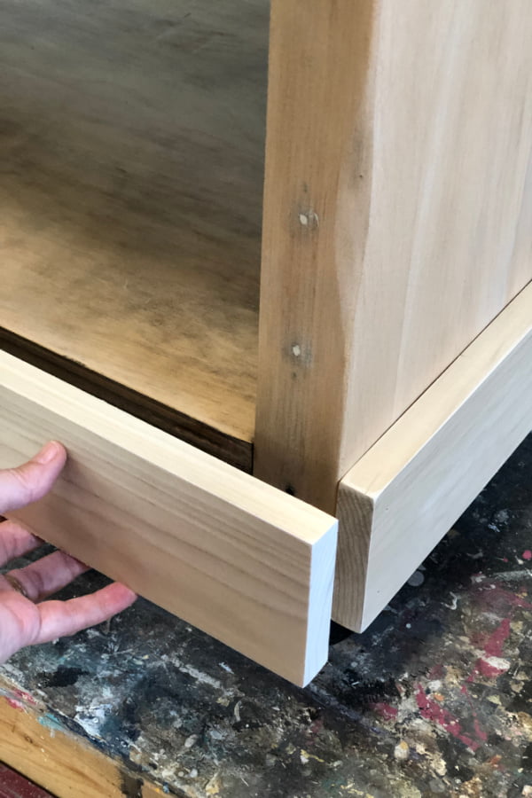 To give my DIY rolling kitchen island stability, I wrapped the base with a 1 X 4 board.