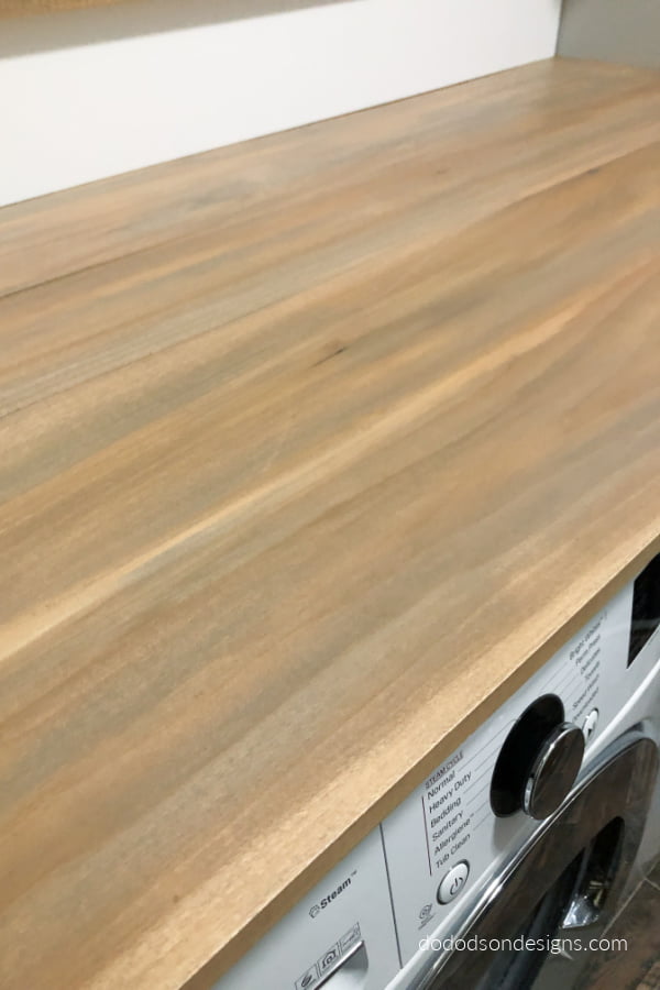 I love how the weathered wood finish looks on my folding station. My laundry room makeover is looking great!