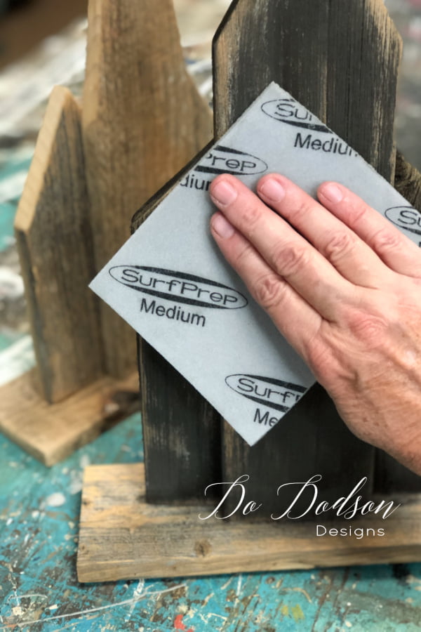 The DIY wooden churches were distressed with a medium grit sanding pad to give them that rustic look.