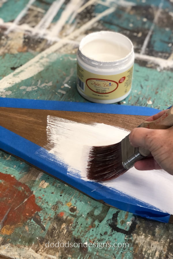 Paint over the wood church using a chalk mineral paint and remove the tape immediately afterwards.