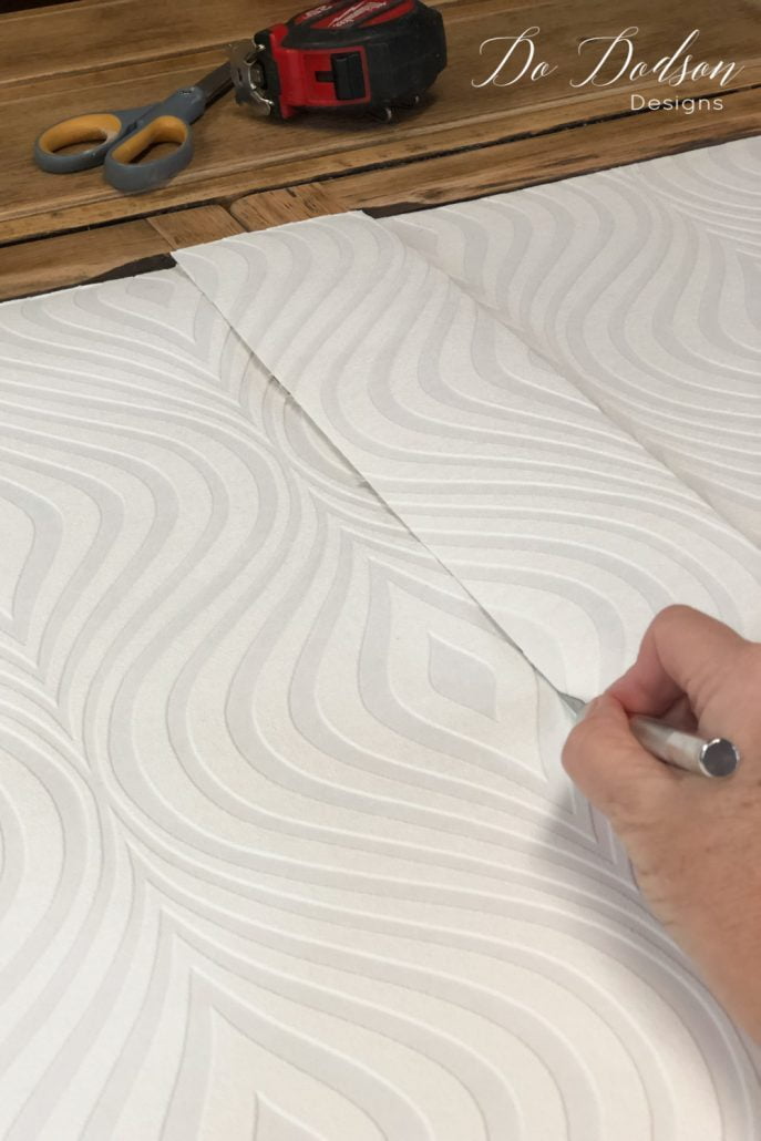 I cut the paintable wallpaper to fit the inside of this cabinet dresser and glued it in place. Next, I'm going to paint it!