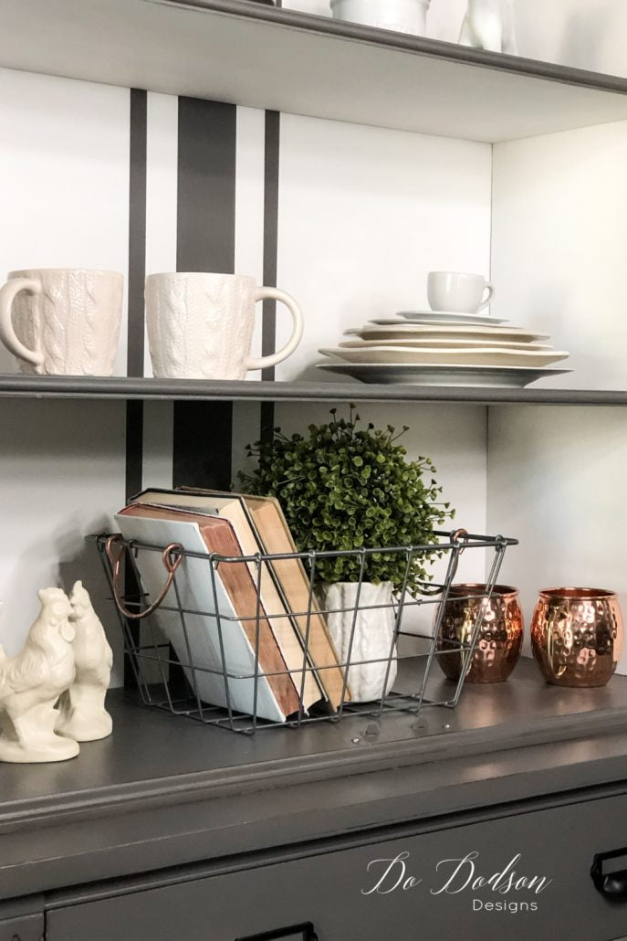 Books, books, book! Another stylish way to use books in your home decorating is to add them to baskets with another décor item. Adding a simple vase and some greenery will give you texture and warmth in those small spaces. The baskets are perfect for holding the books in place without bookends. So trendy!