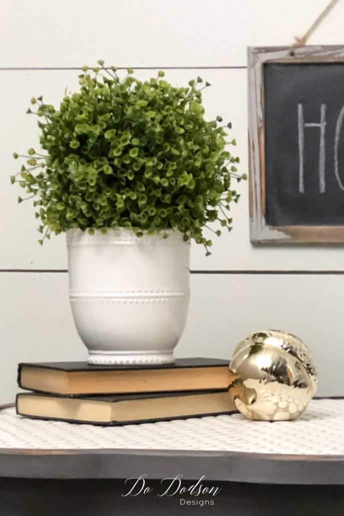 The visual triangle design is also found here using books. Try using books as a riser for the vase to give it more height, and then add a small item beside it. Simple and not overdone; classy, clean lines.