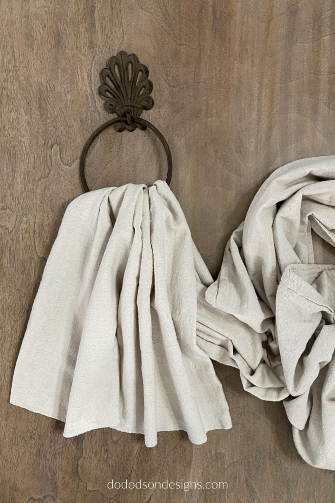 Pull the drop cloth panel through the hanger leaving large pleats at the fold. This will allow the DIY drop cloth window treats to hang nicely.