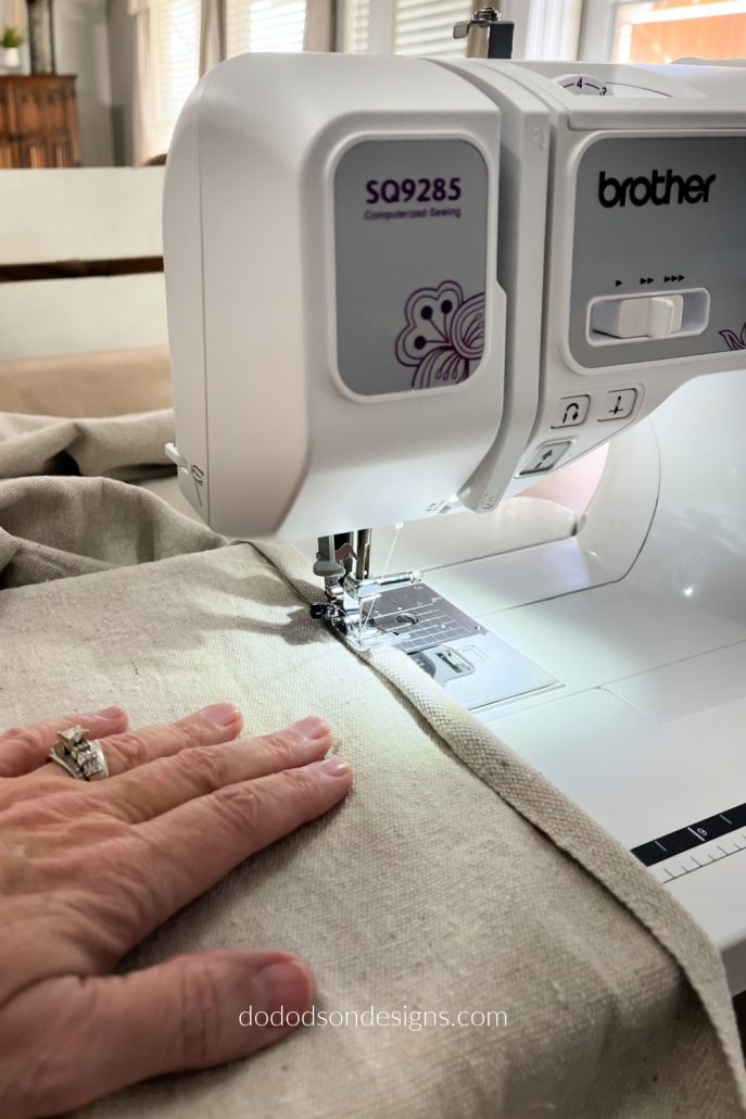 After cutting the drop cloth panels, use your sewing machine or no-sew iron on hem tape to finish the look.