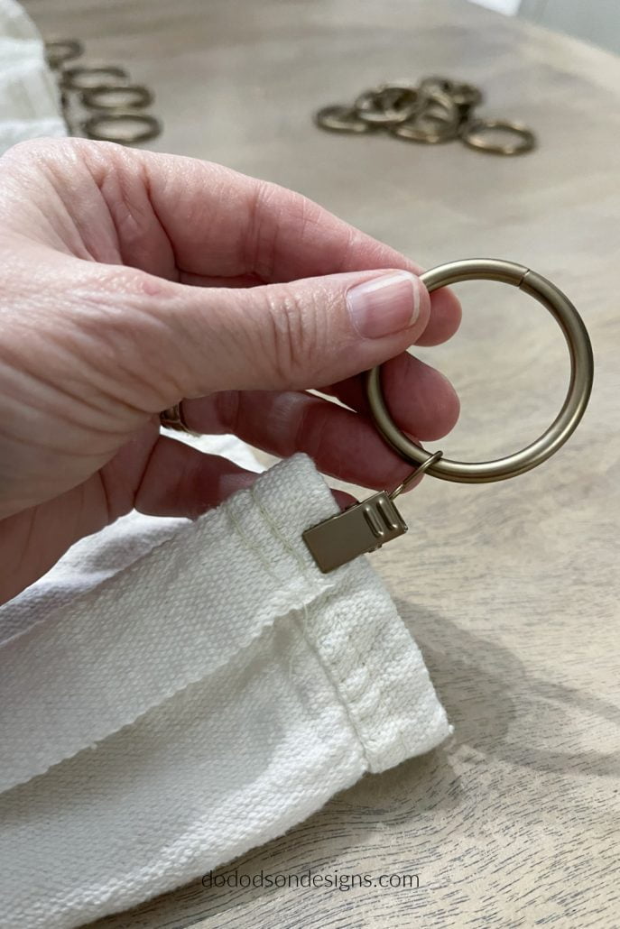 Fold back the ends of your DIY drop cloth curtains before attaching the ring clip. It hides the unfinished ends and gives it a smooth look when hung.