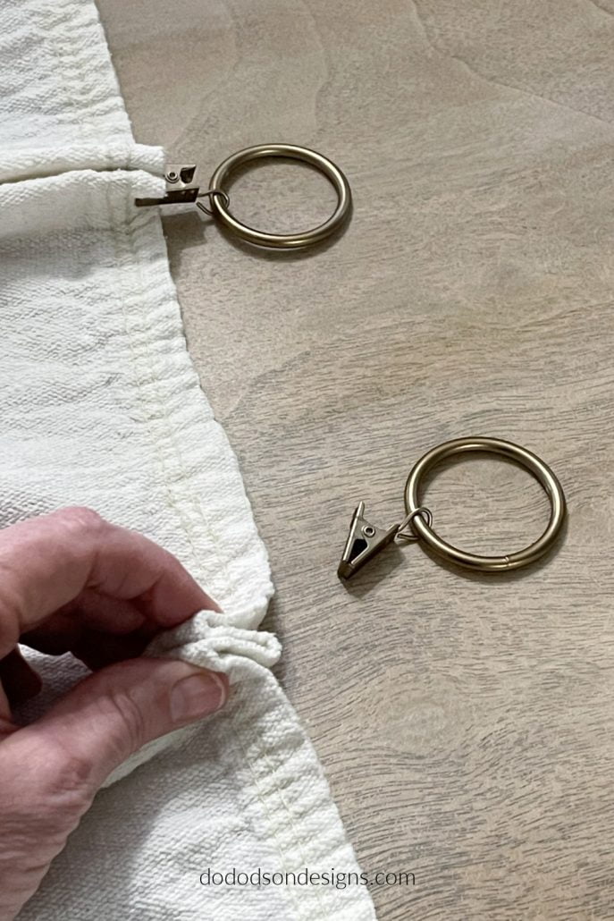 Try adding these simple pleats using curtain ring clips to hang your DIY drop cloth curtains.