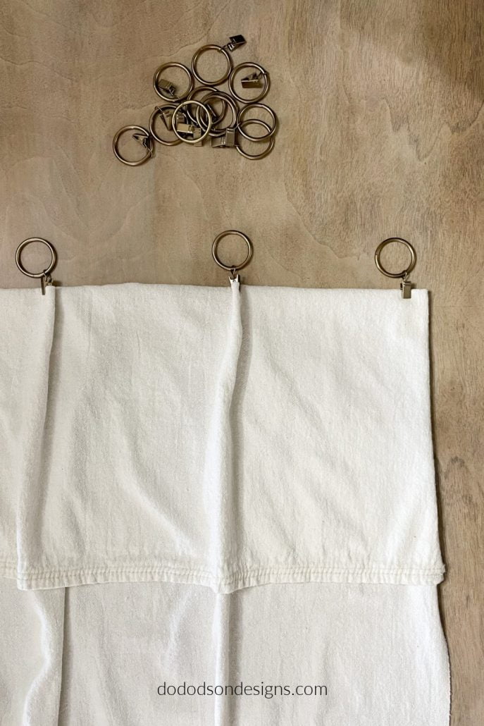 I created a valance with my drop cloth curtains and hung them with curtain ring clips for a traditional look.