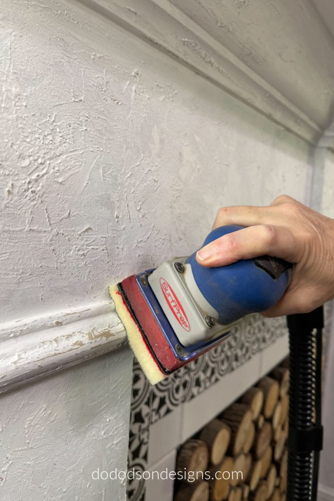 To create the DIY chipped paint look, I used my SurfPrep sander to remove the top layer of paint to reveal all that chippy goodness underneath. I love how my fireplace mantel turned out.