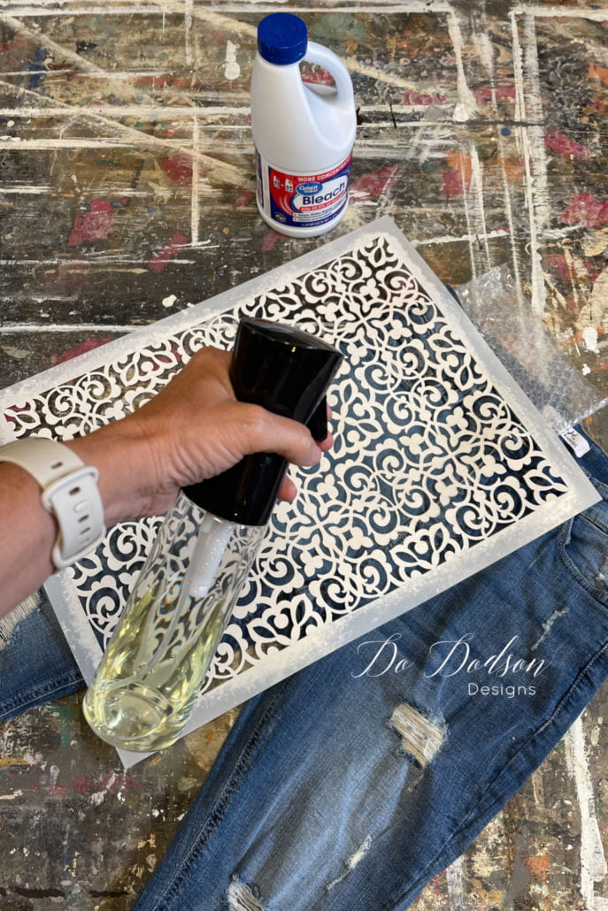 Spray mist the bleach over the stencil. The bleach will cause the fabric to lighten and you will have instant stenciled jeans. Super easy DIY.
