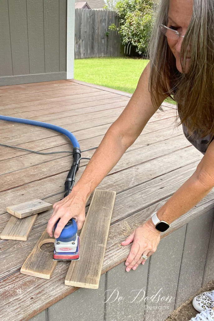 Now is a good time after cutting the holes to smooth out any rough areas on the wood. For this project, I choose to leave the wood rustic as is. But there is no reason that you couldn't paint it a pretty color or add your own style to a wood vase holder.