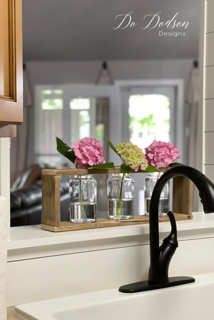 Oh my goodness, these are too stinking cute! Immediately I placed the wood vase holder in the opening of my kitchen passthrough. L-O-V-E them so much! Now I can enjoy my beautiful hydrangeas all day inside and out.